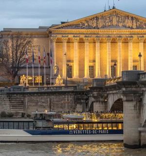 a boat on the water in front of a bridge
