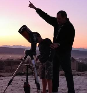 a man and a woman standing next to a camera