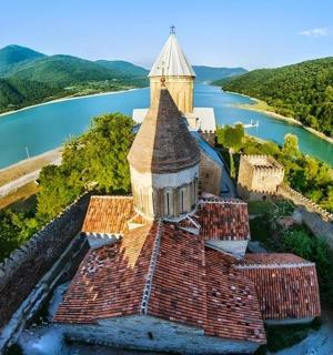 an aerial view of a building next to a river