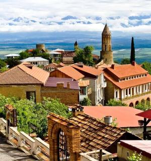 a view of a town with a clock tower and buildings