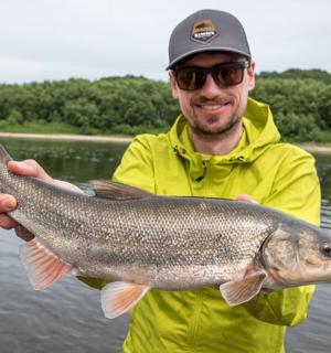 a man holding a large fish in his hand
