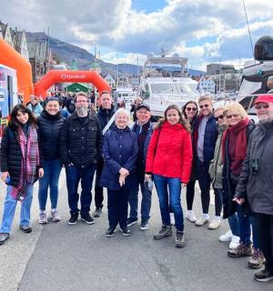 a group of people posing for a picture on a boat