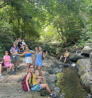 一群人坐在溪边的岩石上