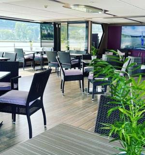 a restaurant with tables and chairs and windows