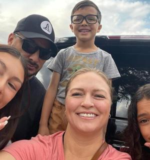 a group of people standing in the back of a truck