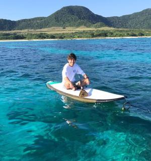 a man sitting on a surfboard in the water