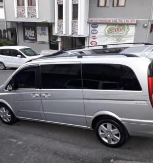 stříbrná dodávka zaparkovaná na kraji ulice