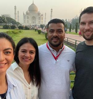 a group of people standing in front of the taj mahal