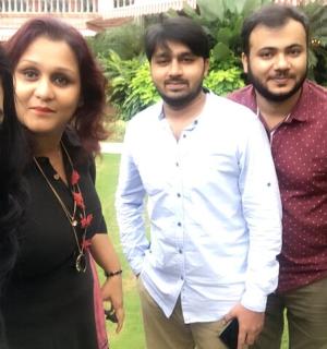 a group of four people posing for a picture