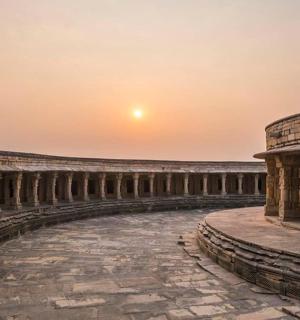 an empty amphitheater with the sunset in the background