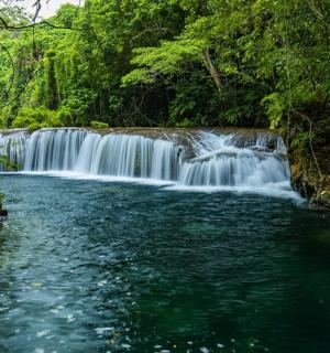 a waterfall in the middle of a river