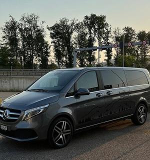 a black and silver van parked at a traffic light