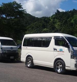 two white vans parked on the side of a road