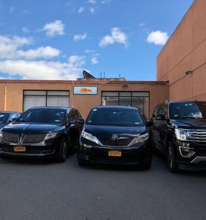 a group of four cars parked in front of a building