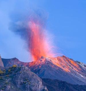 a mountain with a red lava field on top of it