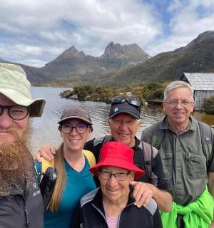 a group of people standing in front of a body of water