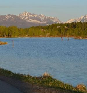 a large body of water with mountains in the background