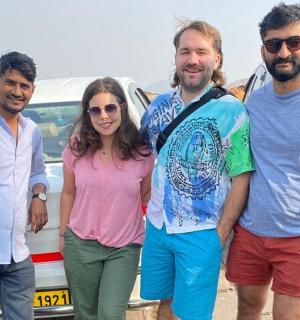 a group of people standing in front of a car