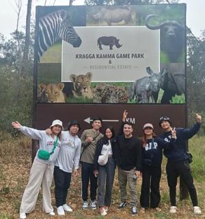 a group of people standing in front of a sign