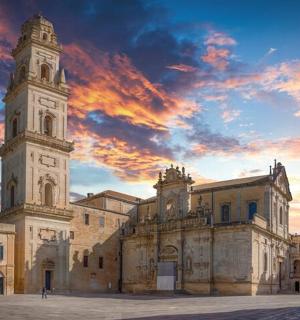 a building with a clock tower and a cloudy sky