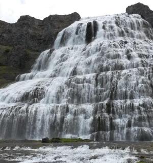 a large waterfall in the middle of a river