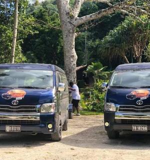two blue trucks parked next to each other