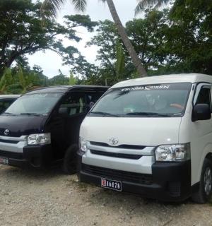 two white vans parked next to each other