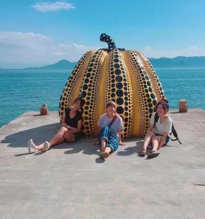 a group of people sitting on a pier in the ocean