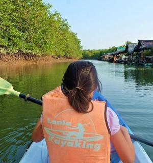 a young girl in a kayak on a river