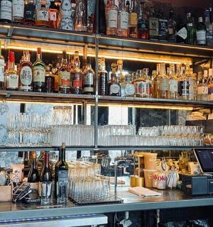 a bar filled with lots of bottles and glasses