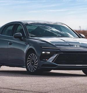 a blue car is parked on a road