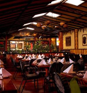a restaurant with tables and chairs with napkins on them