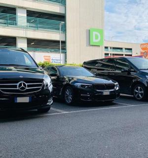 three cars parked in a parking lot in front of a building