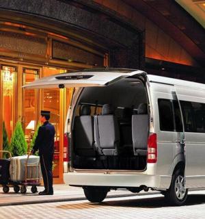 a man standing in the back of a van with an umbrella