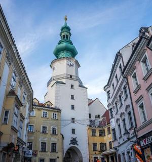 a tall building with a clock tower in a city