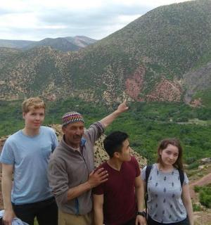 a group of people standing on top of a mountain