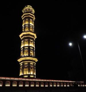 a tall tower on top of a building at night