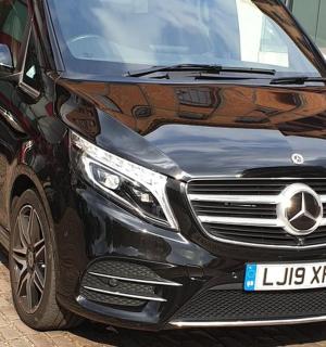 a black mercedes benz car parked on a street
