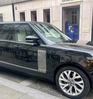 a black car parked on the side of a street
