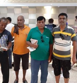 a group of men standing in a lobby