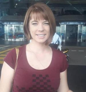 a woman is posing for a picture in a building