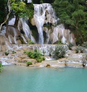 a waterfall in the middle of a pool of water