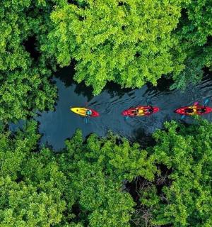 three boats in the water in a river