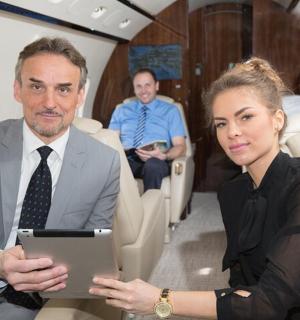 a man and a woman sitting in an airplane