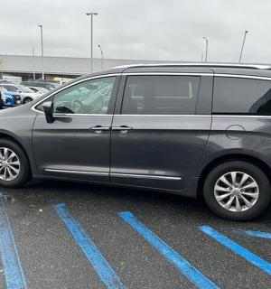a silver van parked in a parking lot