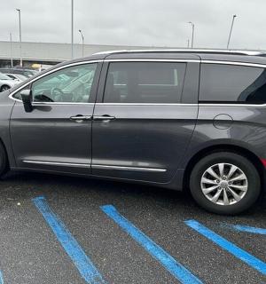 a silver van parked in a parking lot