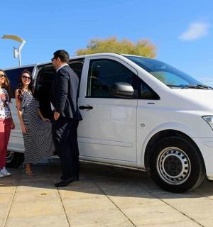 a group of people standing next to a white van