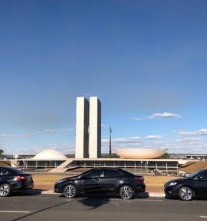 four cars parked in a parking lot in front of a building