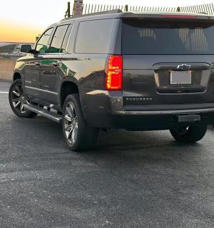 a black suv parked in a parking lot