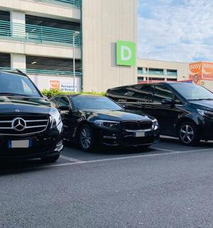 three cars parked in a parking lot in front of a building